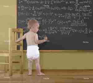 Caucasian baby doing math on blackboard